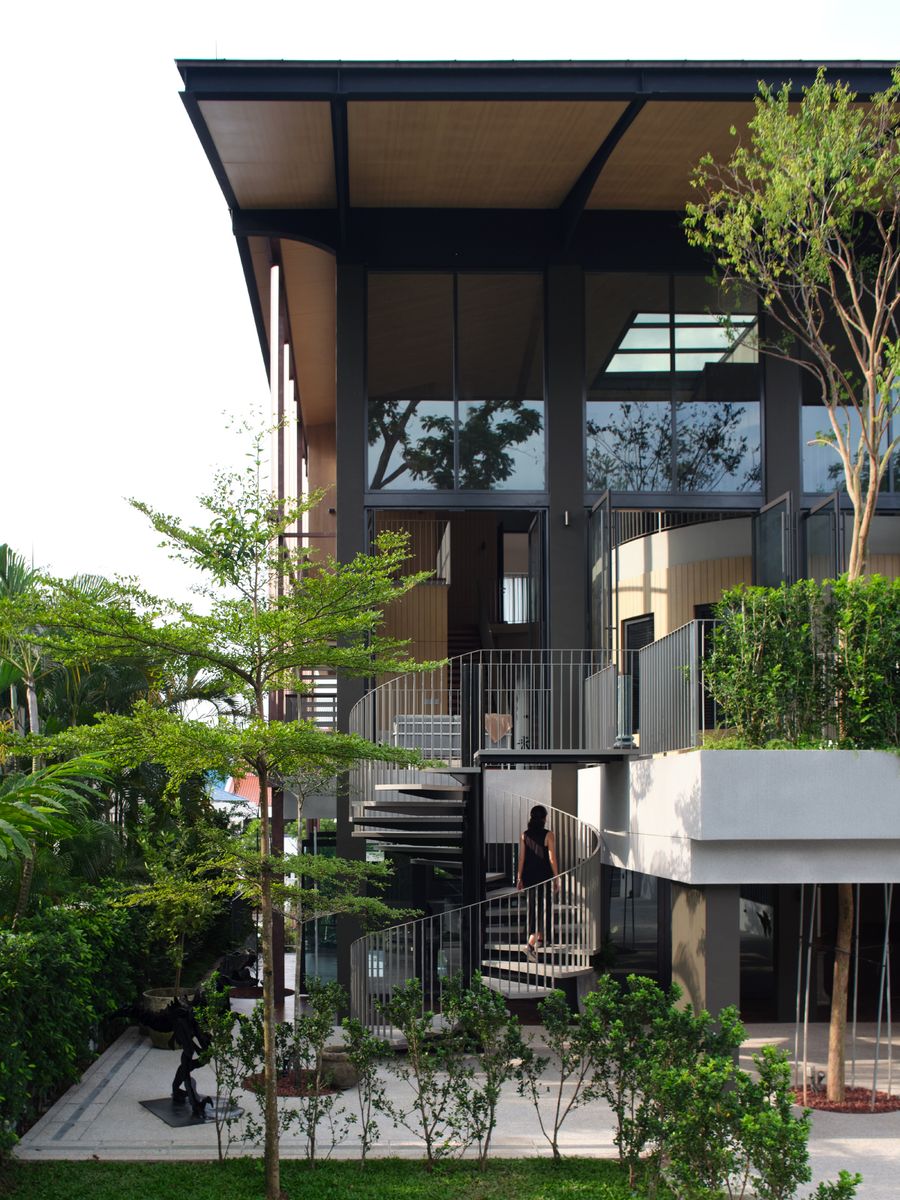 The exterior spiral stair of The Outdoor House, rising beside the car porch to the children's floor