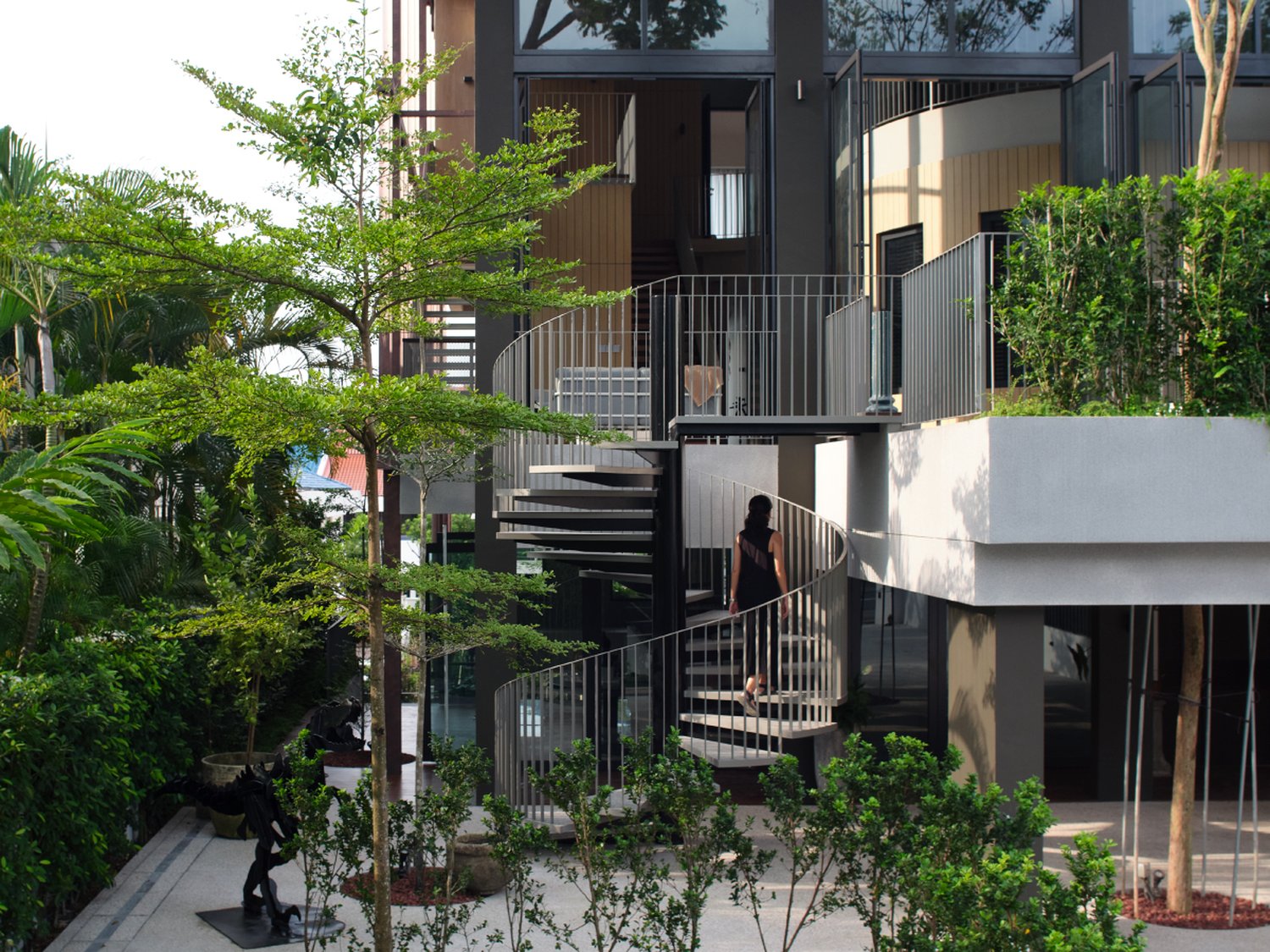The Outdoor House: the spiral stair rising from the garden to the upper terraces